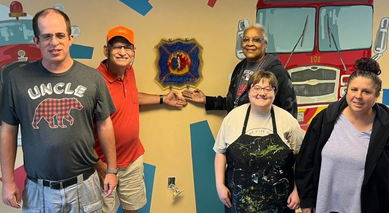 Group of people with Inspo Studios Firehouse Mural